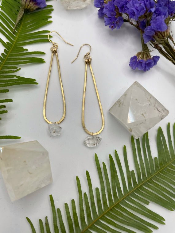 gold hammered metal thin teardrop hoops with single herkimer diamond hanging off the bottom of each shape