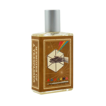 Full size perfume bottle of flat rectangular shape with a paper label wrapped around resembling a book cover