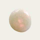 drop of nail polish to show colour. white clearing base filled with reflective sparkles showing a yellowish pink ton shining through