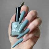 Swatch of colour on fair skinned hand colour is a warm blue with dusty undertones