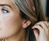 Woman wearing turquoise studs showing miniature size and colour