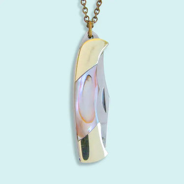 Close-up of mother-of-pearl nice necklace showing handle carved from mother-of-pearl with gold accents