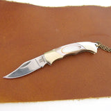 Detail shot of knife open on whether background knife is sharp and pointed handle is reflecting light