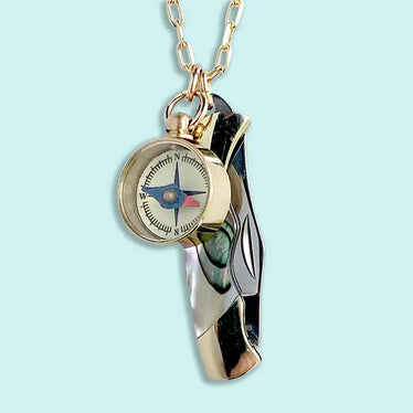 necklace features a tiny pocket knife with an abalone handle hanging off of a golden tone chain with a small golden compass hanging