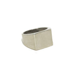 Signet ring showing empty square geometric shape on neutral background