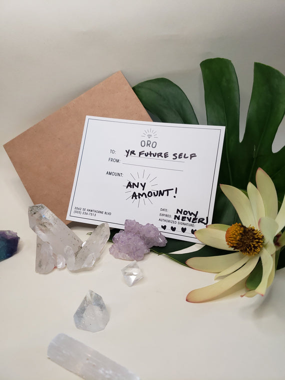 A paper gift card that says to your future self for any amount surrounded by crystals and flowers￼