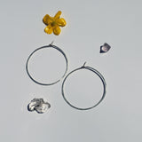 Small circle hoops lying flat showing size and light reflecting qualities of the metal