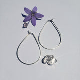Small teardrop hoops showing hand hammered texture pointed top and round bottom