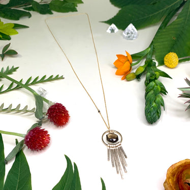 Hexagon fringe necklace on white background with decorative flowers showing long length and one single cutting smoky quartz bead