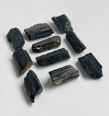 Detail shot of black tourmaline chunks showing white reflections in the light