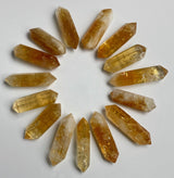 double sided citrine points laying flat in a circle catching the light￼