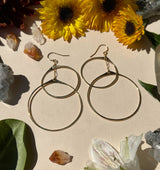 Detail shot of double circle hoops shows the gold reflecting brightly in direct sunlight