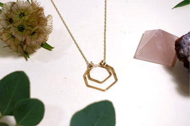 up close shot of hand hammered detailing on the double hexagon necklace￼