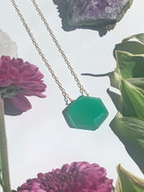 Dainty gold necklace with green onyx hexagon stone in middle
