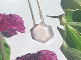 Dainty gold necklace with rose quartz hexagon stone in middle