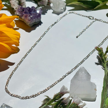 Shot of small silver Figaro chain necklace showing size and length