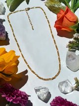 Small Figaro chain necklace on neutral background