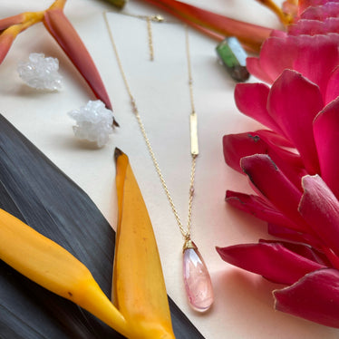 Rose Quartz teardrop necklace on my background with flowers and crystals