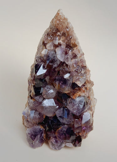 Close-up shot of amethyst cluster showing beautiful purple towns large crystals and light reflecting qualities