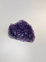 Small amethyst cluster showing multiple the light reflecting points and deep purple color