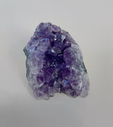 Small amethyst cluster showing multiple light reflecting points and deep purple color