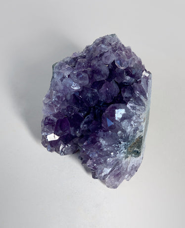 Small amethyst cluster on neutral background