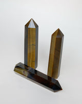 three tigers eye obelisks on neutral background