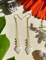 stone kite ladder earrings hanging by two strands of gold chain with three opal beads suspended between. 