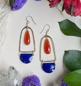 Hammered belle earrings featuring a orange carnelian teardrop stone encapsulated by a hammered gold shape with a lapis half circle hanging off the bottom￼