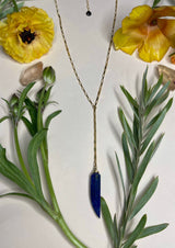 small gold box chain with lapis okra shaped stone hanging off of a small length of chain from the middle 