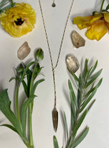 small gold box chain with smokey quartz okra shaped stone hanging off of a small length of chain from the middle 