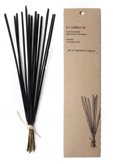 bundle of black incense sticks next to cardboard box they come in