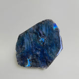 Close-up shot of labradorite slab showing bright blue flash