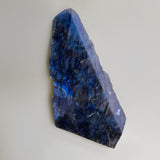 large labradorite slab and neutral background slab is wider at the bottom slightly pointed at the top and polished on two sides￼