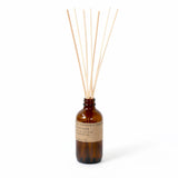 amber glass reed diffuser on white background 