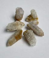 Gordon spirit quartz cluster points laying in a circle on a neutral background￼