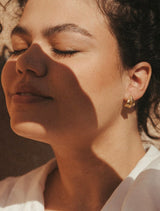 woman wearing sahara hoops. shows medium size on ear and gold texture