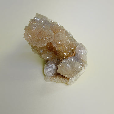 Abstract shaped spirit quartz cluster on neutral background