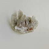 Mineral cluster laying on neutral background
