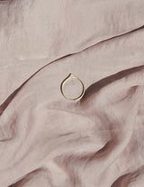 Stella ring on fabric background shows thin gold band with sharp triangular point