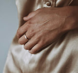 Person wearing Stella ring shows light reflecting and thin band