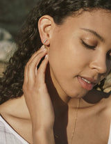 woman wearing tagus earrings. shows bright blue colour and small size