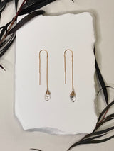 threader earrings featuring a tiny delicate gold chain and a wire wrapped Herkimer diamond on the end￼