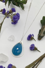 close-up shot of chalcedony and Sterling version the stone as a bright blue tone reflecting faceted light￼