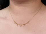 Woman wearing freshwater pearl mini chain necklace the necklace hangs right above collarbones￼