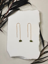 threader earrings featuring a tiny delicate gold chain with a green tourmaline rod hanging on the end￼