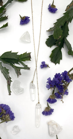 necklace has a dainty gold chain with two raw quartz points hanging off of two separate short chains