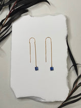 threader earrings featuring a tiny delicate gold chain and a square shaped blue kyanite hanging off the end￼