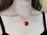 Dainty gold necklace with carnelian hexagon stone in middle