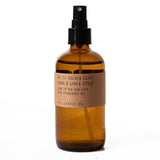 Amber glass spray bottle with brown paper label and black spray nozzle￼